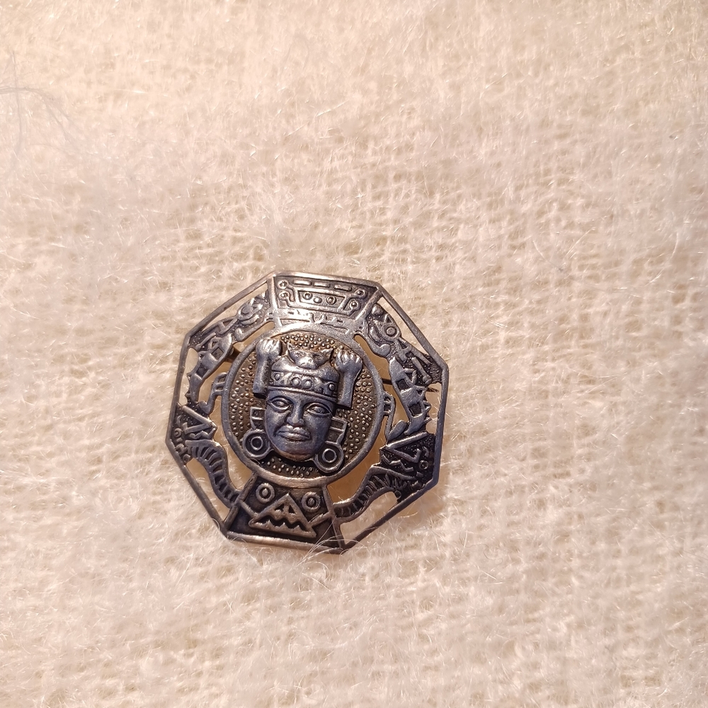 Silver Peruvian head brooch
